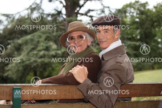 Elderly couple sat on bench