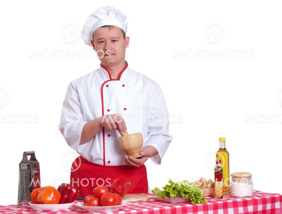 Handsome man cooking in the kitchen at home