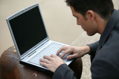 Young man typing on his laptop