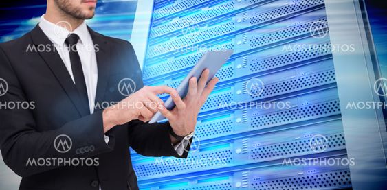 Composite image of mid section of a businessman using digital tablet pc