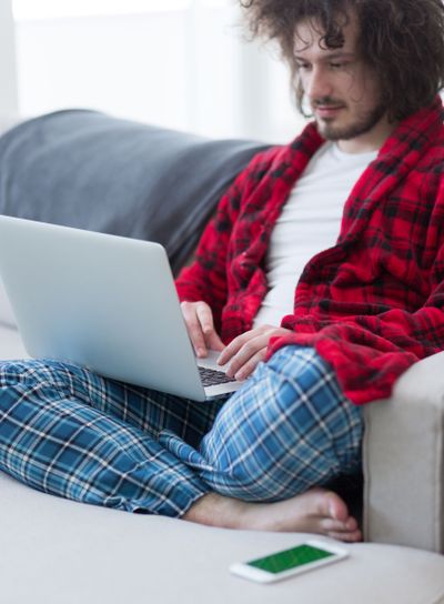 man freelancer in bathrobe working from home
