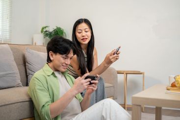 A lovely Asian couple spends time together at home,...