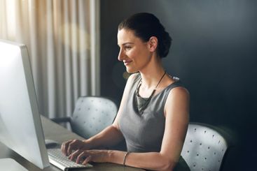 Technology, typing and businesswoman in office for...