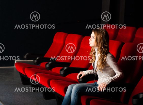 young attractive woman sitting in a cinema