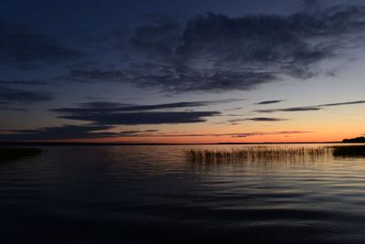 Pink strip afterglow of sunset on the horizon comes night