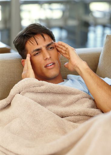 Sick, headache and man with blanket, pain and flu season...