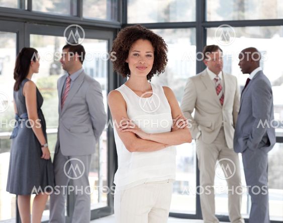 Beautiful Afro-american Businesswoman arms folded with his colleagues