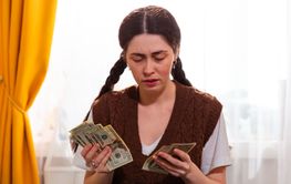 Portrait of Caucasian woman tracking household expenses...
