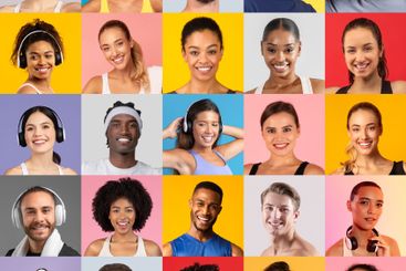 Diverse group of smiling individuals expressing joy in...