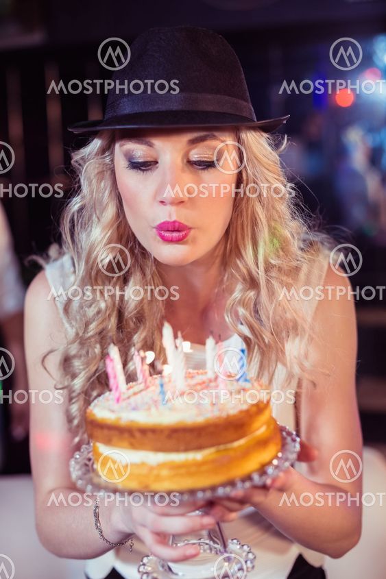 Woman blowing out candles