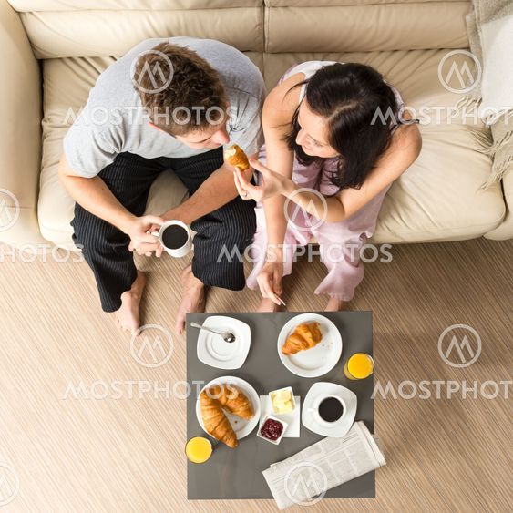 Carefree couple eating breakfast together