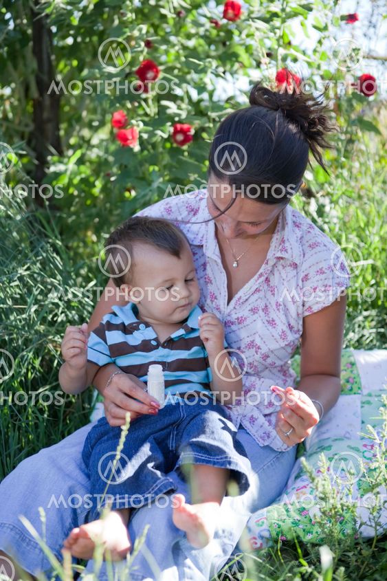 Mother giving homeoptahic medicine to her son