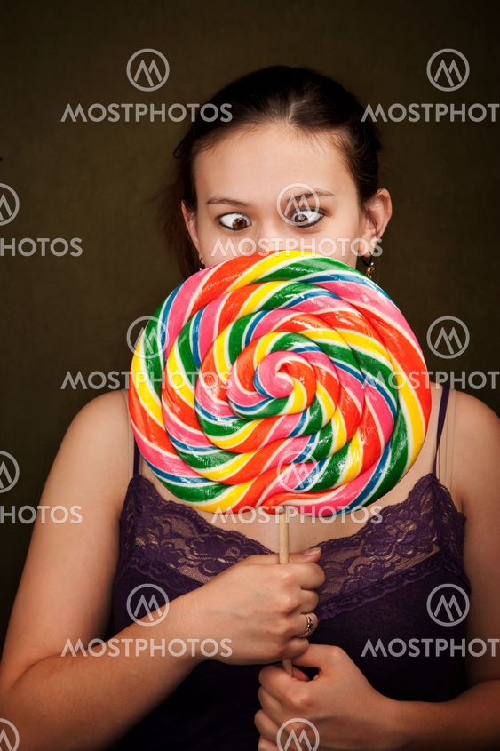 Pretty Girl in Purple on Green Background with Lollipop