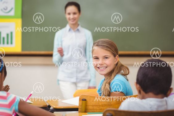 Pupil smiling at camera during class