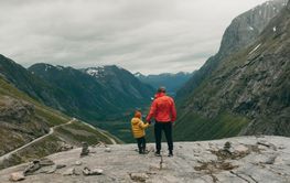 Father and daughter hiking on mountain