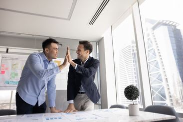 Happy successful multiethnic male business colleagues...