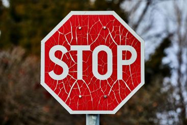 Stop sign with broken paint peeling