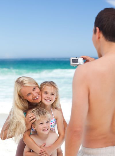 Man taking a photo of his family