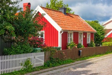Idyllic red cottage on a street in a Swedish town