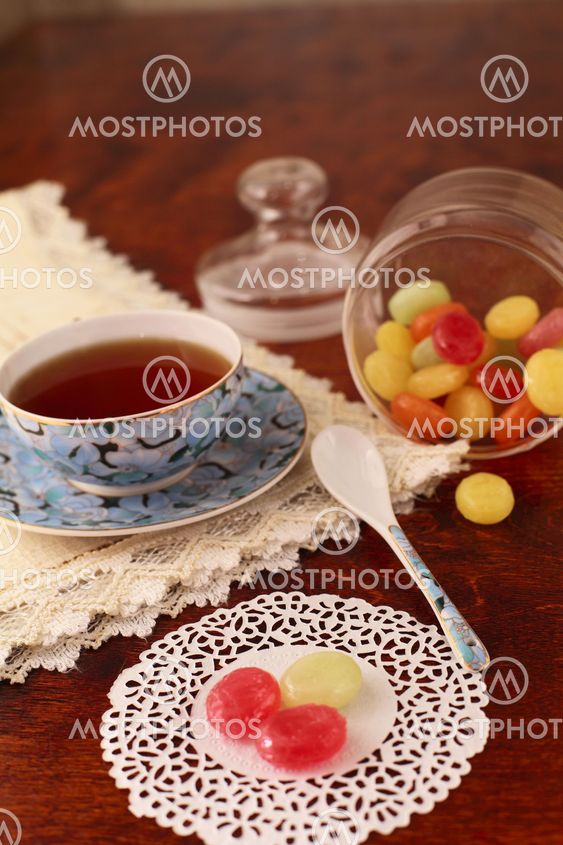 Tea with coloured sugar candies in a glass can