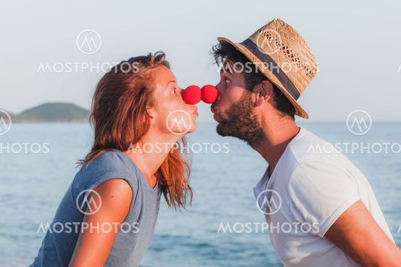 Funny young couple in love on the beach