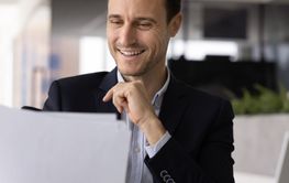 Happy legal financial business expert reading document at...