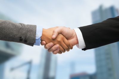 businessman and businesswoman shaking hands