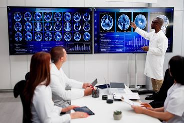 Doctors In Clinic Looking At Brain MRI Scan