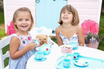Two young girls play outdoors
