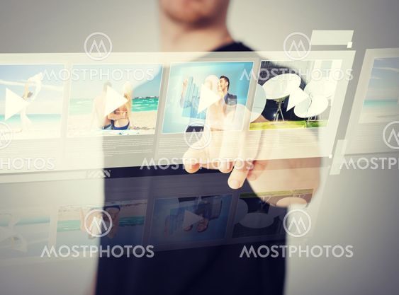man pressing button on virtual screen