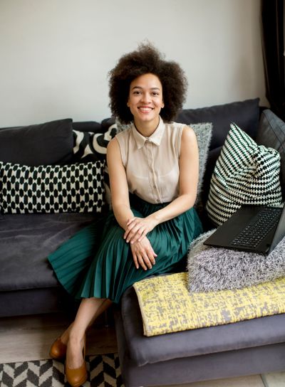Attractive young woman working on laptop at home