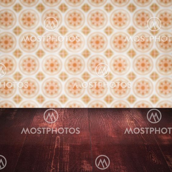 Wood table top and blur vintage ceramic tile pattern wall