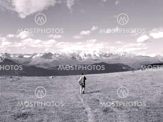 A man walking on a background of mountains
