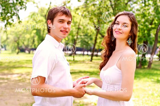couple holding hands in the park