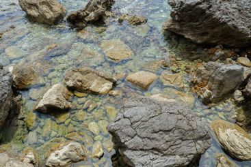 Beautiful rocks and bright turquoise water among layered...