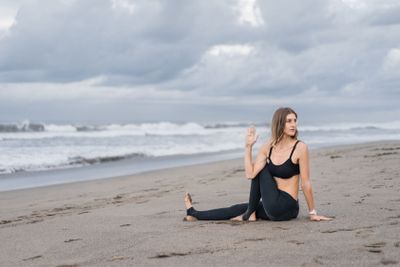 fit young woman practicing yoga in Marichis III pose on...