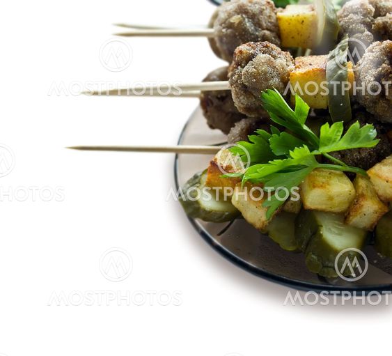 Background with roast meatballs on skewers