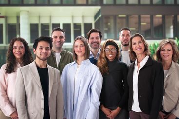 Diverse Group Of Professionals Cooperating Outside A...