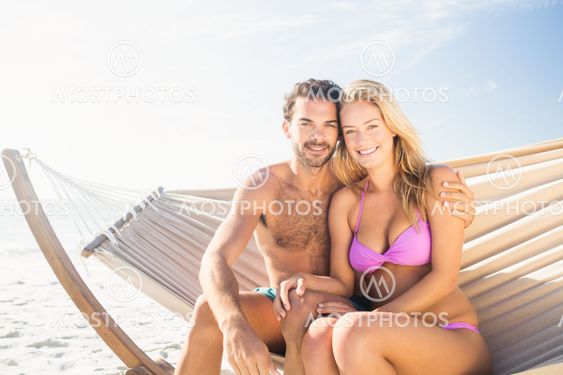 Smiling couple sitting in hammock