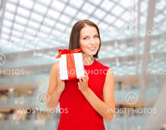 smiling woman in red dress with gift box