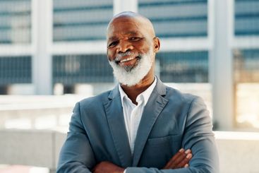 Arms crossed, business and portrait of black man in city...