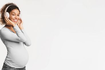 Pregnancy and motherhood concept. Black pregnant woman...