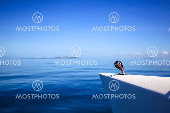 Bow of a sailing boat in calm blue sea