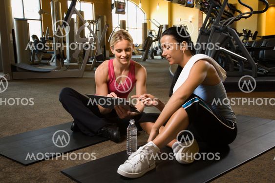 Woman with trainer at gym.