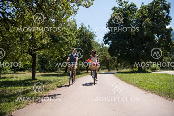 Young multiethnic couple having a bike ride in nature