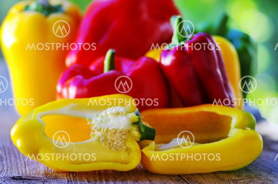 red, yellow and green pepper on table