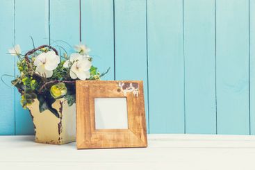 Cozy pastel wooden home decor objects on blue background