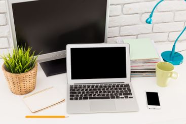 Home office workspace featuring laptop, monitor, and...
