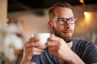 Coffee, thinking and man in restaurant with remote work...