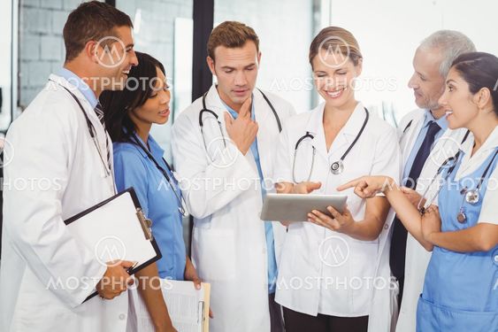 Medical team interacting and using digital tablet